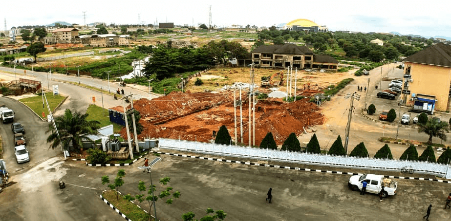 Aerial view of active gate remodelling works with excavator and red earth